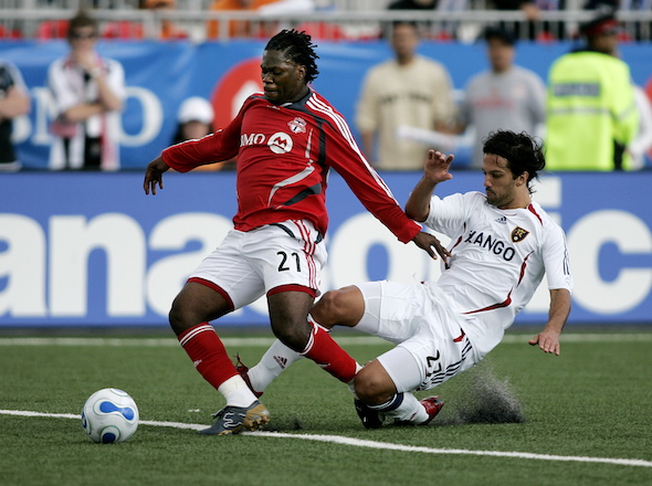 Toronto FC's Collin Samuel  fights for the ball with Real Salt Lake's Matias Mantilla during their MLS soccer match in Toronto