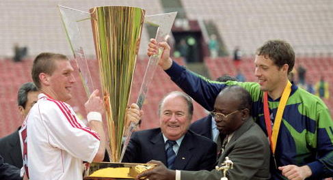 I love how De Vos gets real close to the trophy and forces Warner and Blatter to squeeze into Forrest's underarm. 